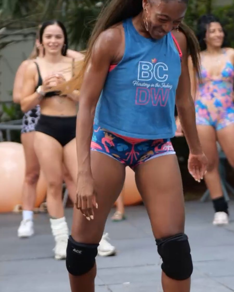 Instructor in a blue tank leading class